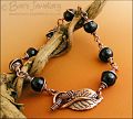 Copper and onyx wire wrapped bracelet with leaf toggle clasp
