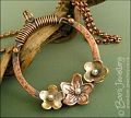 Hammered copper ring with bronze and copper flowers