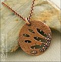 Textured copper pendant drizzled with tiny raindrops