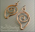 Loosely spiralled leaf shaped hammered copper earrings