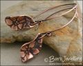 Antiqued copper earrings with flower charms and long feature earwires