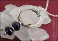 Silver circle pendant wrapped with faceted amethyst rondelles