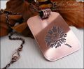 Etched daisy pendant in antiqued copper