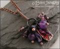 RESERVED - Antiqued copper pendant necklace clustered with purple and copper charms