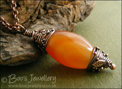Carnelian and decorative bead cap pendant on chain