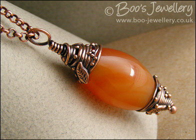 Carnelian and decorative bead cap pendant on chain