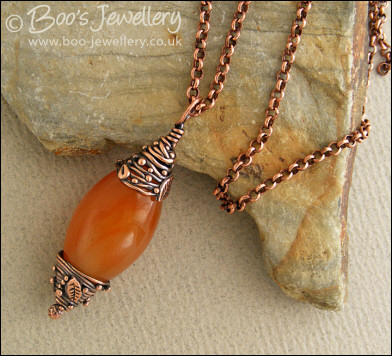 Carnelian and decorative bead cap pendant on chain