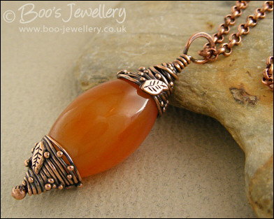Carnelian and decorative bead cap pendant on chain