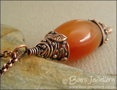 Carnelian and decorative bead cap pendant on chain