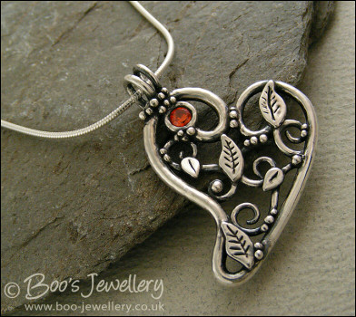 Fine silver filigree heart pendant filled with leaves and scrolls