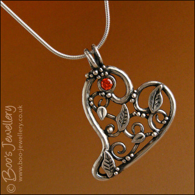 Fine silver filigree heart pendant filled with leaves and scrolls