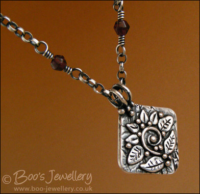 Silver and garnet necklace with square pendant