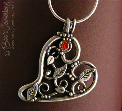 Fine silver filigree heart pendant filled with leaves and scrolls