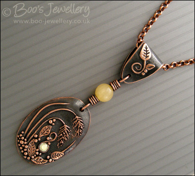 Copper and honey jade pendant with leaves and grasses