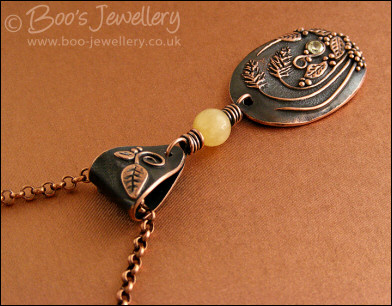 Copper and honey jade pendant with leaves and grasses