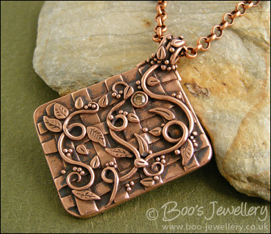 Copper garden trellis pendant festooned with vines and leaves