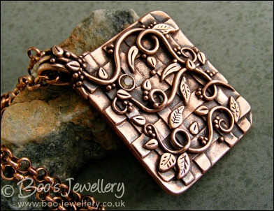 Copper garden trellis pendant festooned with vines and leaves