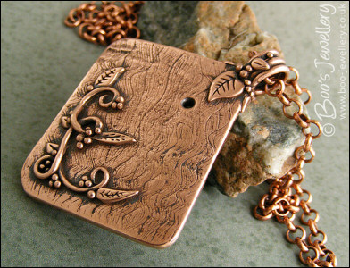 Copper garden trellis pendant festooned with vines and leaves