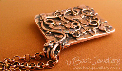 Copper garden trellis pendant festooned with vines and leaves