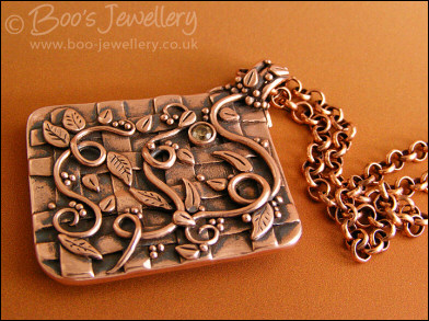 Copper garden trellis pendant festooned with vines and leaves