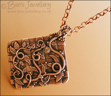 Copper garden trellis pendant festooned with vines and leaves