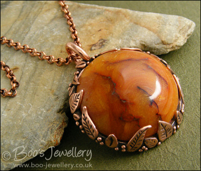 Faux amber cabochon and leaf theme pendant