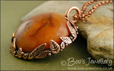Faux amber cabochon and leaf theme pendant