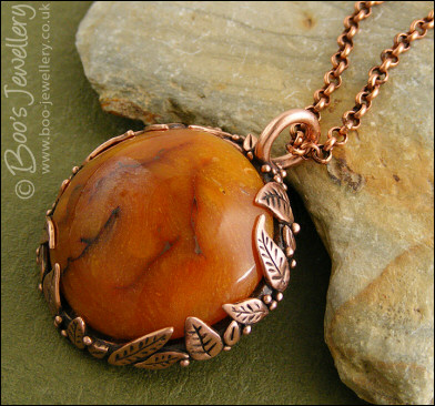 Faux amber cabochon and leaf theme pendant