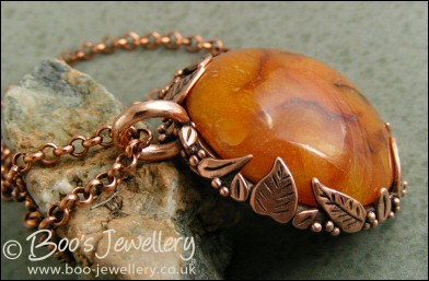 Faux amber cabochon and leaf theme pendant