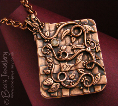 Copper garden trellis pendant festooned with vines and leaves