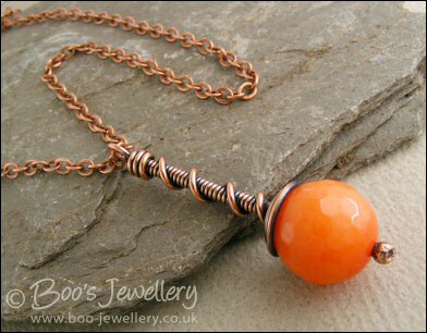 Intense orange coloured faceted jade coil on coil pendant
