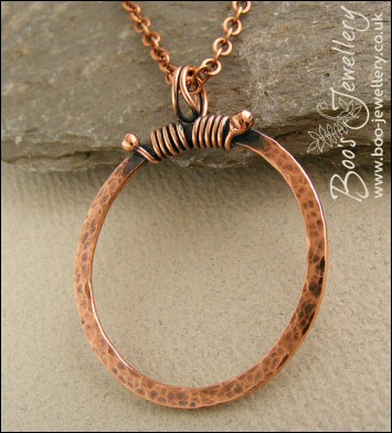 Hammered copper circle pendant with tendril bail