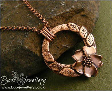 Circle pendant with sculpted wild rose
