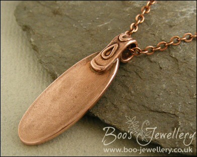 Oval copper pendant with hand drawn geometric design