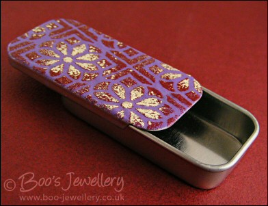 Enamelled sliding lid pillbox wth flowery design