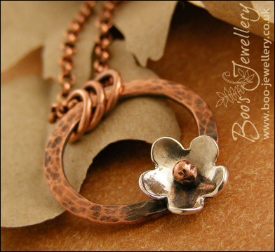 Hammered copper ring pendant with silver flower