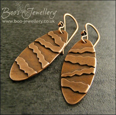Long oval earrings with geometric stripe decoration