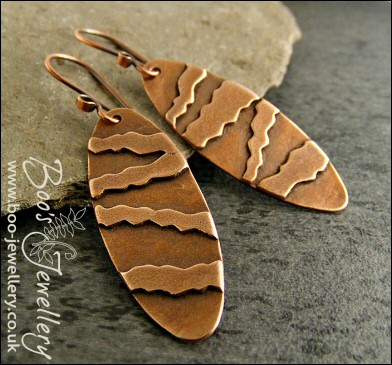 Long oval earrings with geometric stripe decoration