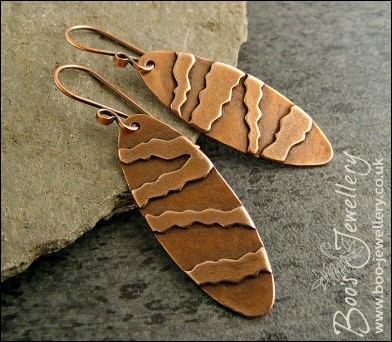 Long oval earrings with geometric stripe decoration