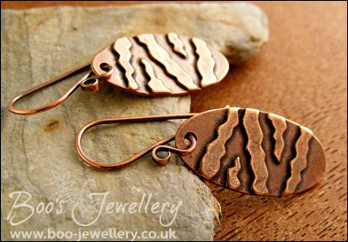Oval antiqued earrings with geometric stripe applique