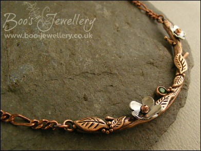 Hand sculpted twig and leaf necklace with silver blossoms