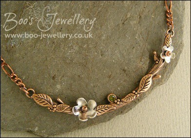 Hand sculpted twig and leaf necklace with silver blossoms