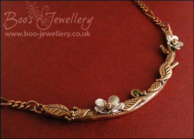 Hand sculpted twig and leaf necklace with silver blossoms