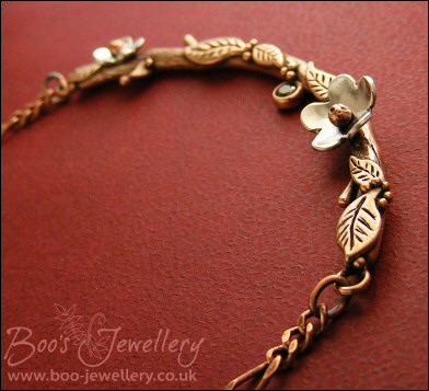 Hand sculpted twig and leaf necklace with silver blossoms