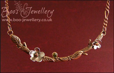 Hand sculpted twig and leaf necklace with silver blossoms