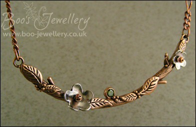 Hand sculpted twig and leaf necklace with silver blossoms
