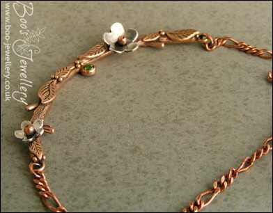 Hand sculpted twig and leaf necklace with silver blossoms