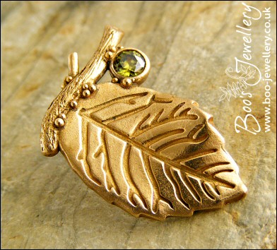 Bronze leaf brooch pin with peridot coloured gemstone