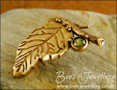 Bronze leaf brooch pin with peridot coloured gemstone