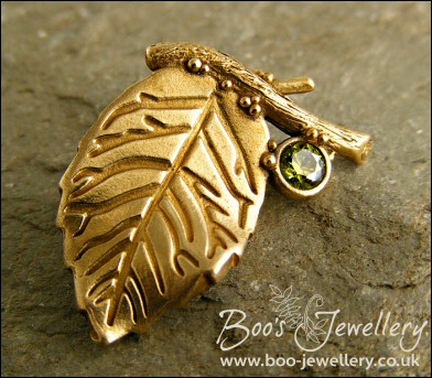 Bronze leaf brooch pin with peridot coloured gemstone